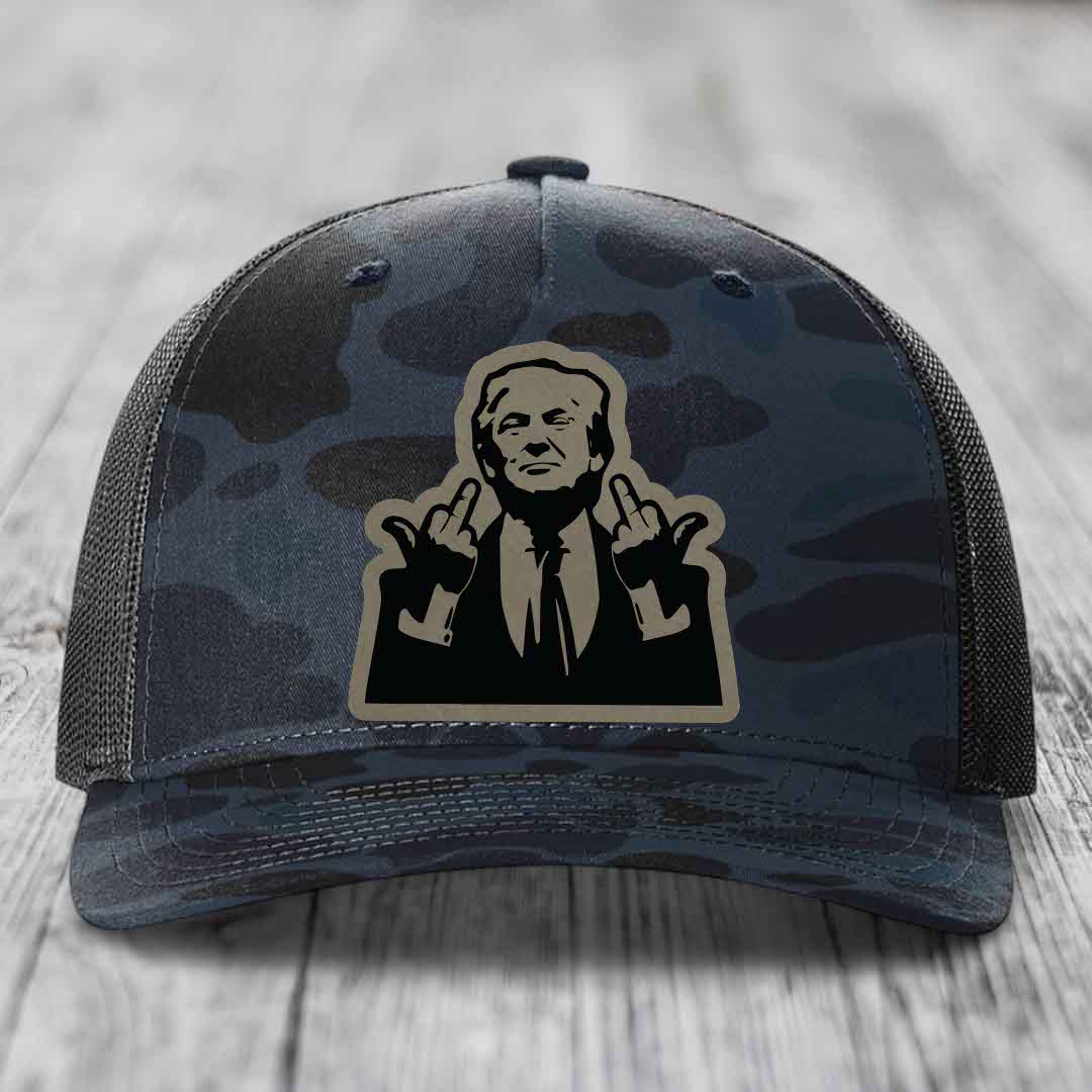 Camouflage trucker hat with a graphic patch of a man making hand gestures.