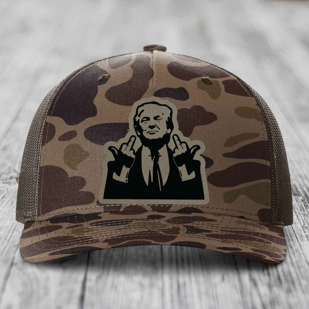 Camouflage trucker hat with a black and beige patch of a man making rude hand gestures.