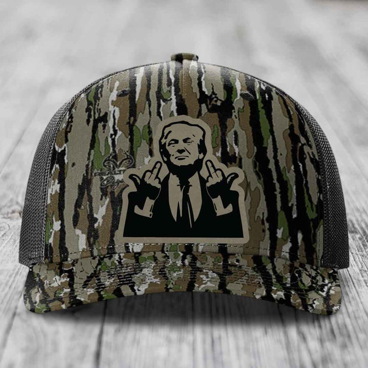 Camouflage trucker hat with black and beige patch of man making rude hand gestures.