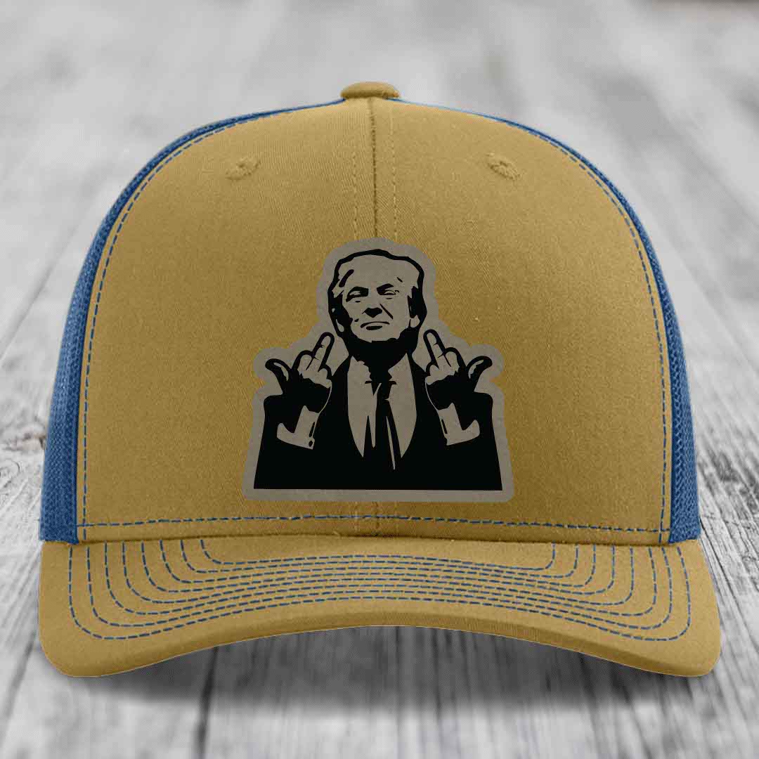 Tan and blue trucker hat with black graphic patch of man making hand gestures.
