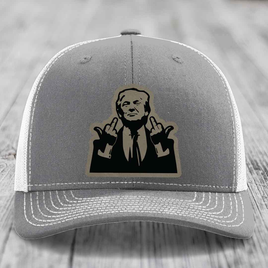Grey trucker hat with white mesh back and stitched details, featuring a black and tan patch of a man making hand gestures.