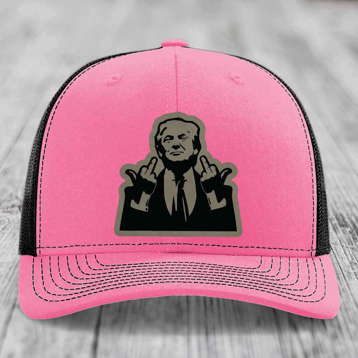 Pink and black trucker hat with a graphic patch of a man making hand gestures.