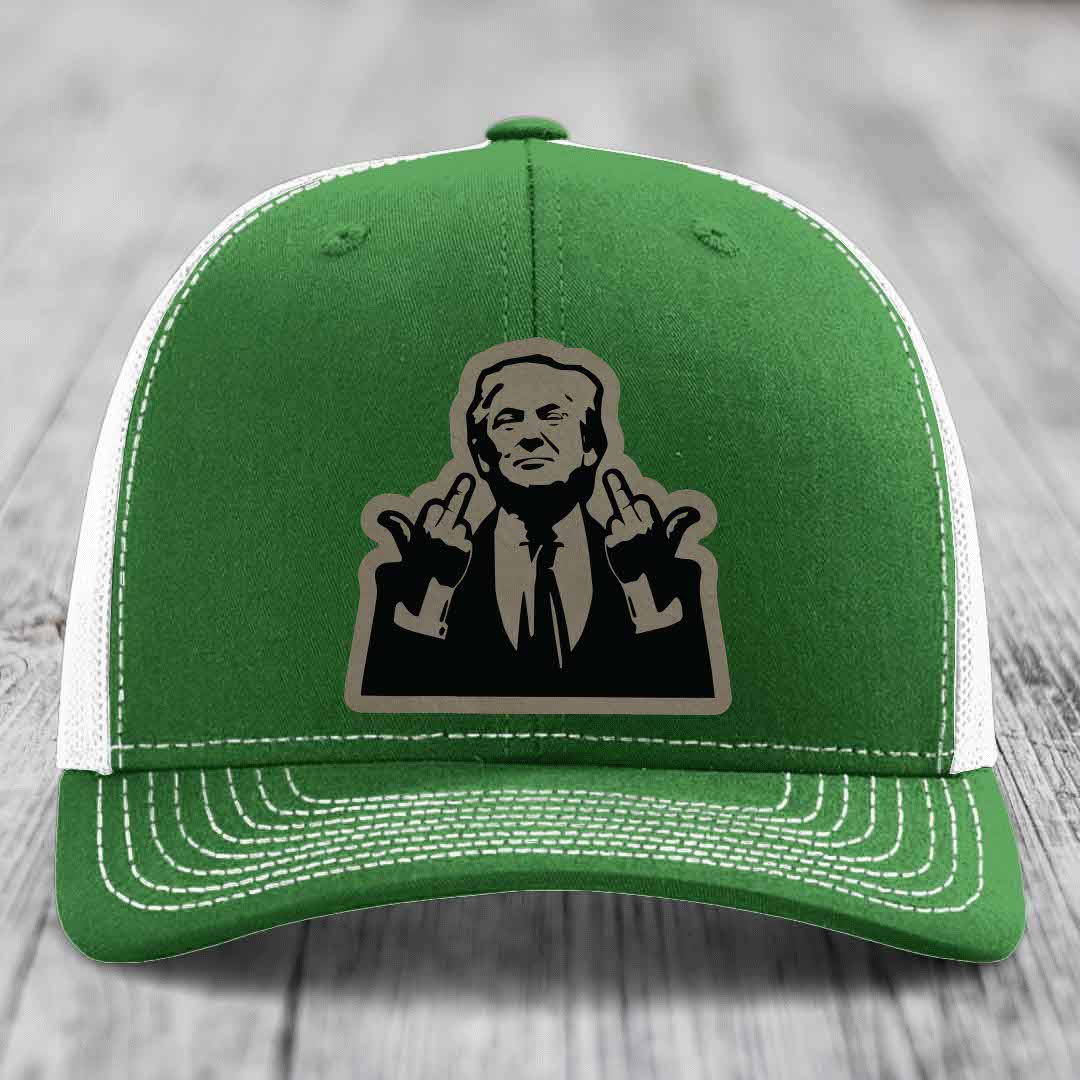 Green trucker hat with white mesh back and stitching, featuring a black and grey patch of a man making hand gestures.