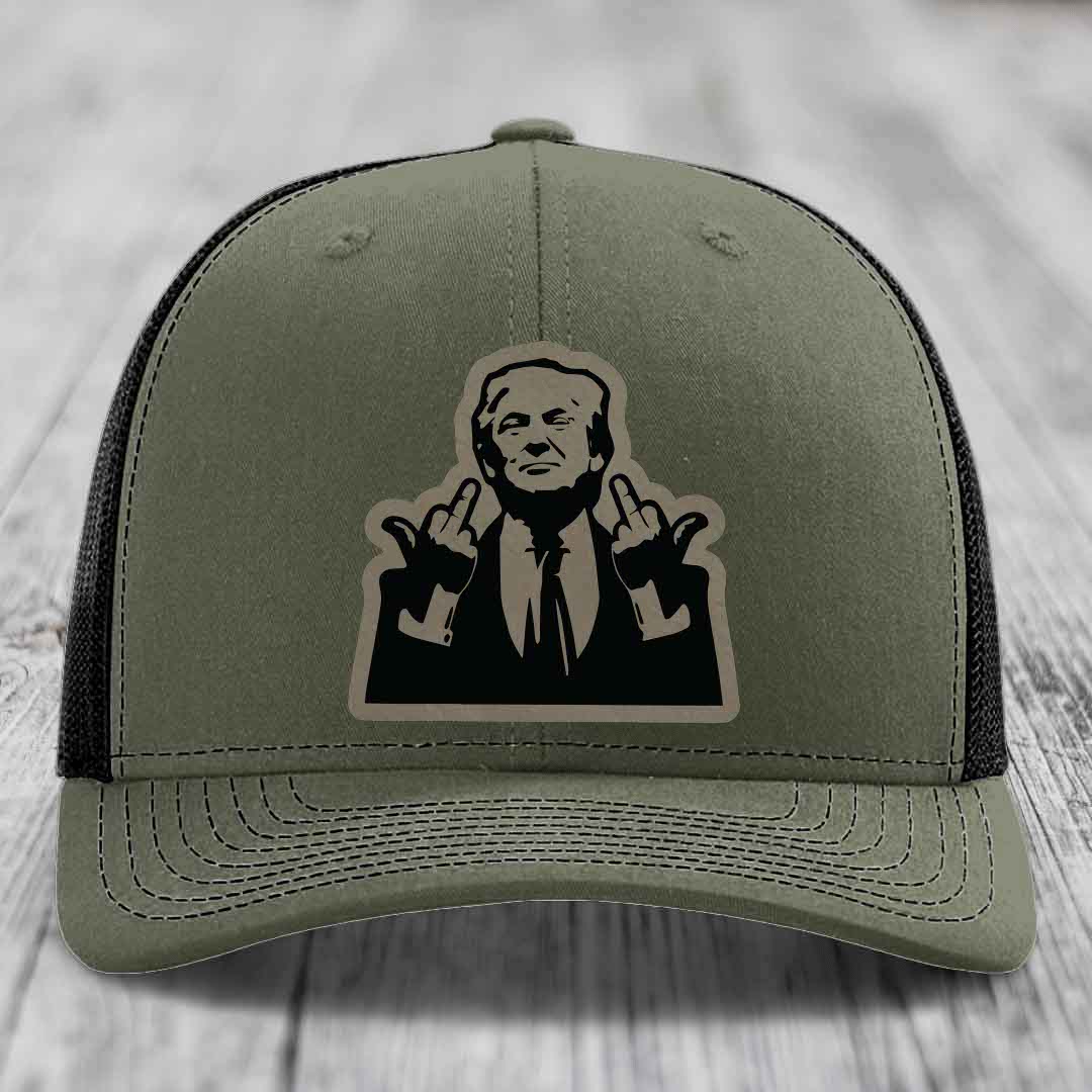 Olive green trucker hat with black mesh back and a large graphic patch of a man making rude hand gestures.
