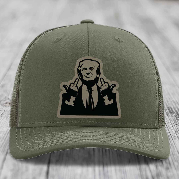 Olive green trucker hat with black and beige patch of a man making rude hand gestures.