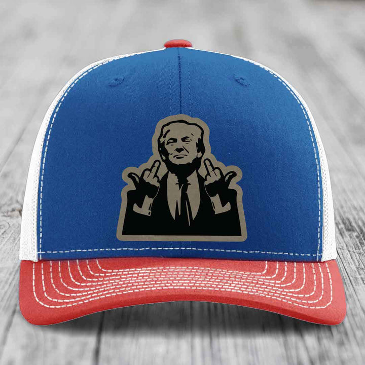Blue and red trucker hat with white stitching and a black-and-grey graphic patch of a man making hand gestures.