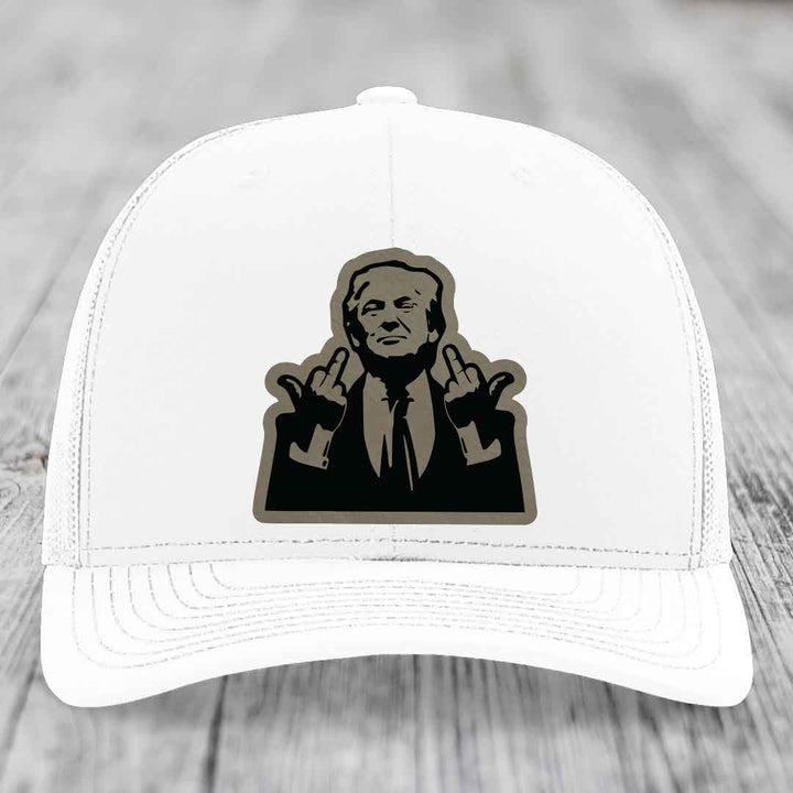 White trucker hat with black and grey patch of man making rude hand gesture