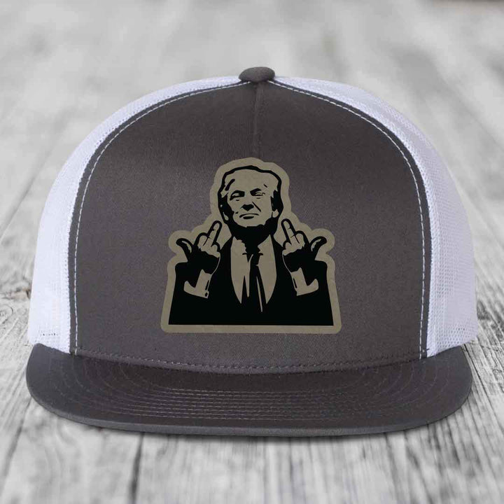 Grey and white trucker hat with a black and tan graphic patch of a man making hand gestures.