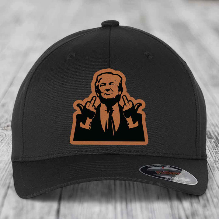 Black baseball cap with orange leatherette patch of man making rude hand gesture.