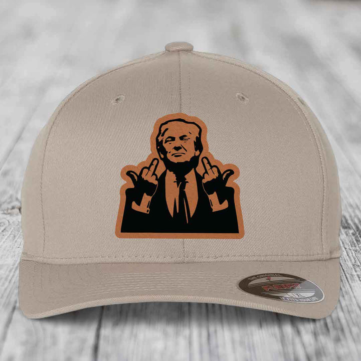 Beige baseball cap with a brown leather patch featuring a silhouette of a man making hand gestures.