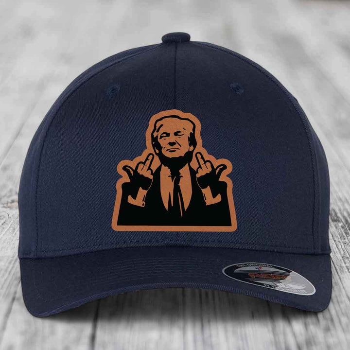 Dark blue baseball cap with orange and black leather patch of a man making hand gestures.