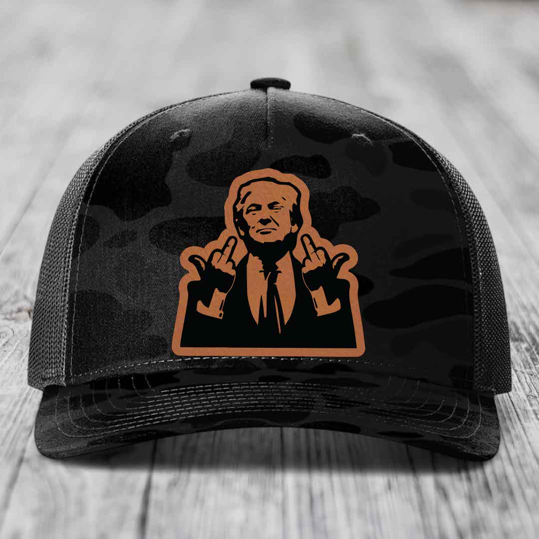 Black camouflage trucker hat with orange leather patch of man giving two middle fingers