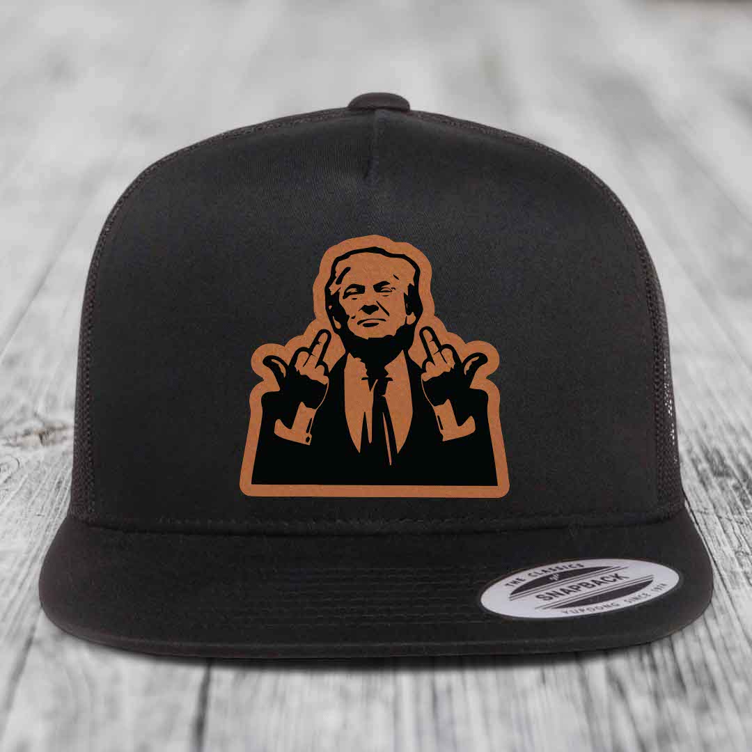 Black snapback trucker hat with tan leather patch of man making rude hand gestures.