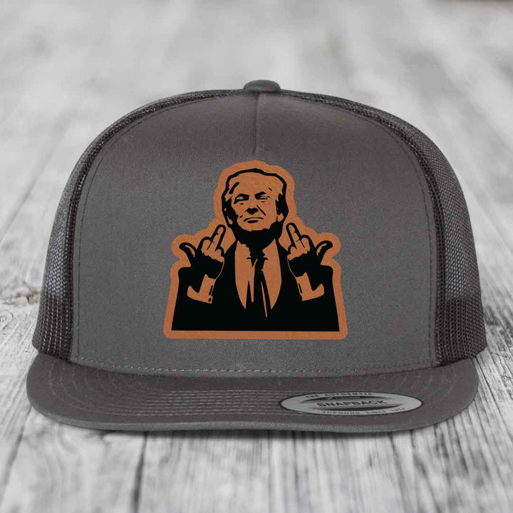 Grey trucker hat with orange and black leather patch of man making rude hand gestures.