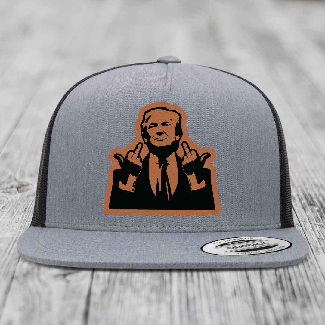 Grey trucker hat with black mesh back and brown leather patch of man giving middle finger