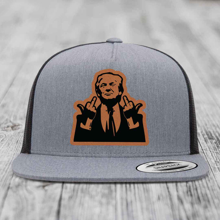Grey trucker hat with black mesh back and brown leather patch of man giving middle finger