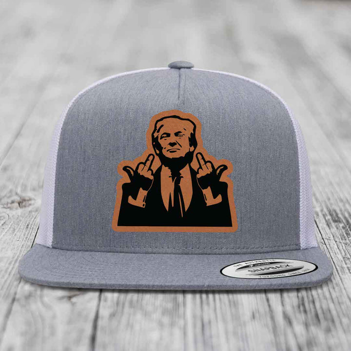 Grey trucker hat with orange and black leather patch of man making rude hand gestures.