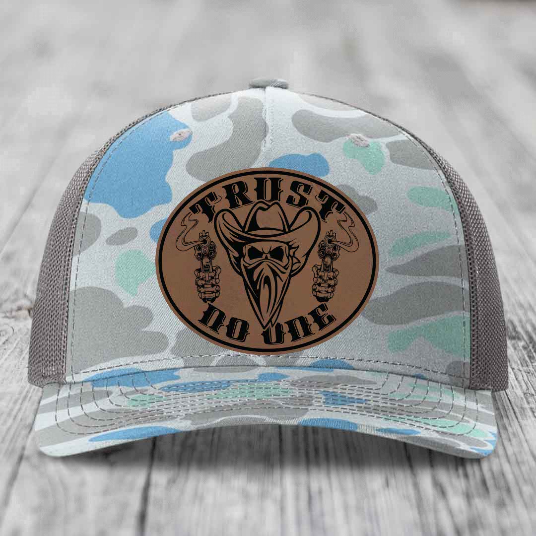 Camouflage trucker hat with brown leather patch featuring &