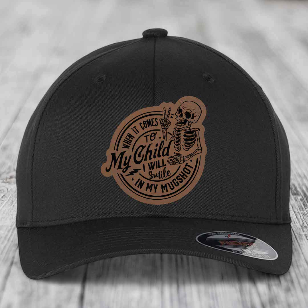 Black baseball cap with brown leather patch featuring skeleton holding peace sign and text &