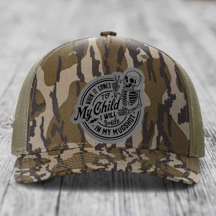 Camouflage trucker hat with skeleton patch reading &