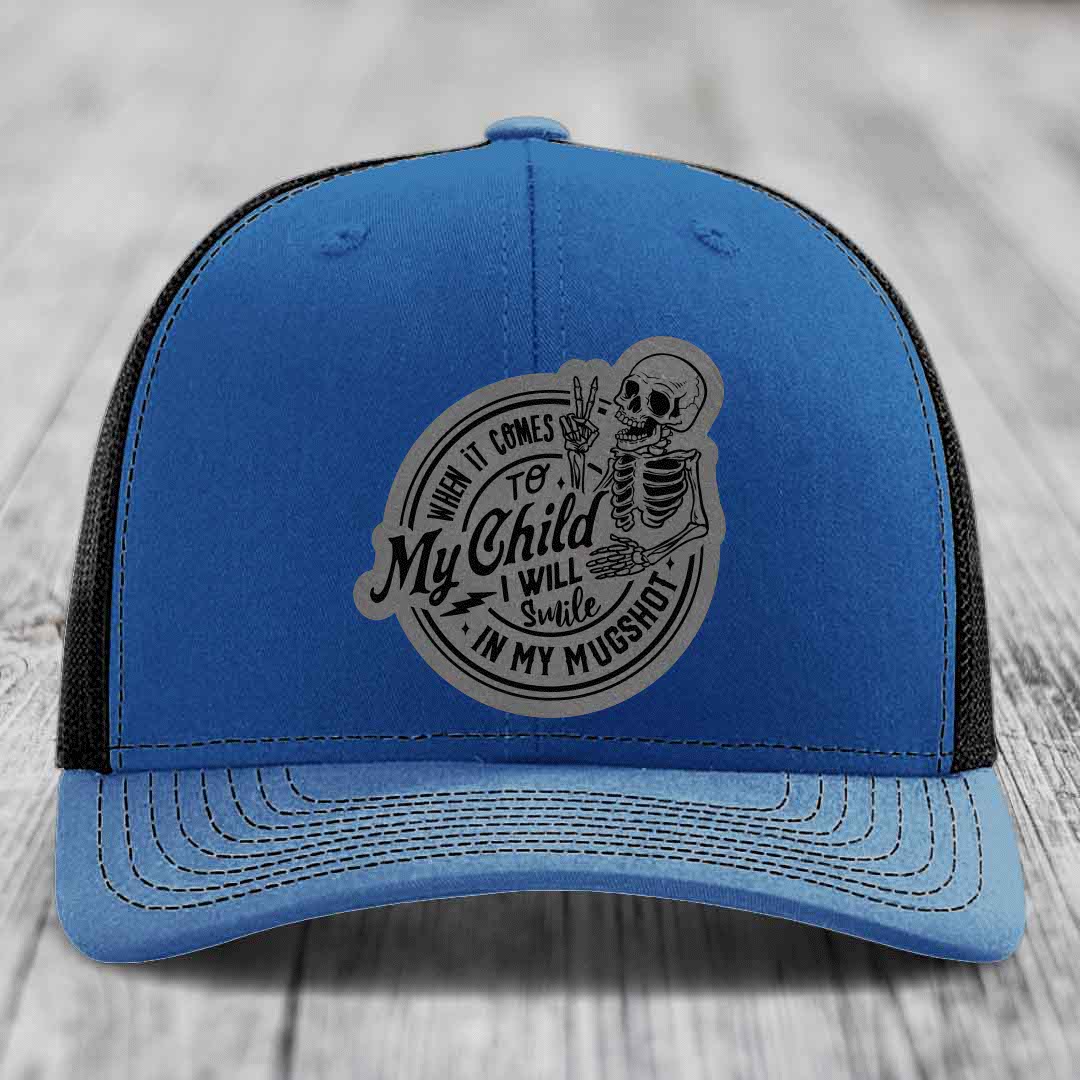 Blue trucker hat with grey skeleton patch reading &