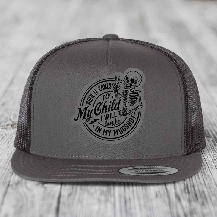 Grey trucker hat with skeleton patch reading &