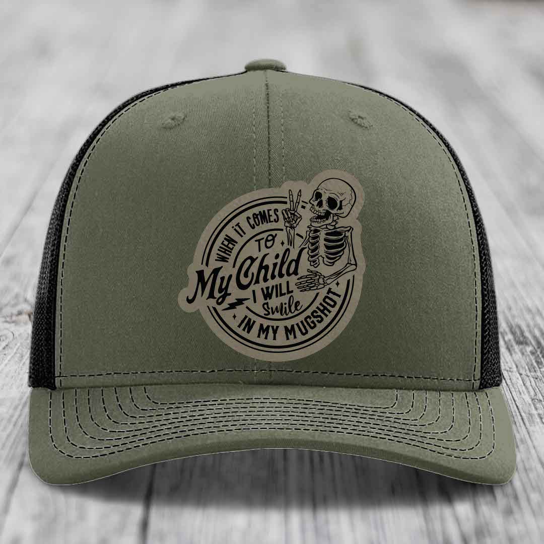 Olive green trucker hat with skull patch reading &