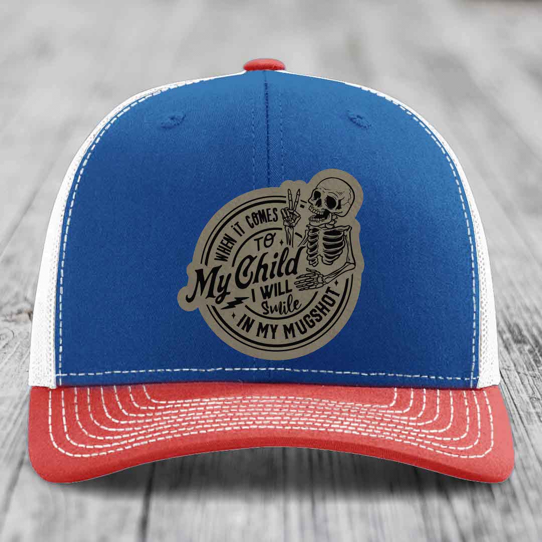 Blue and red trucker hat with skeleton patch reading &