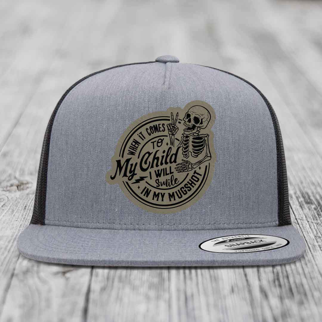 Grey trucker hat with a skeleton patch that reads &