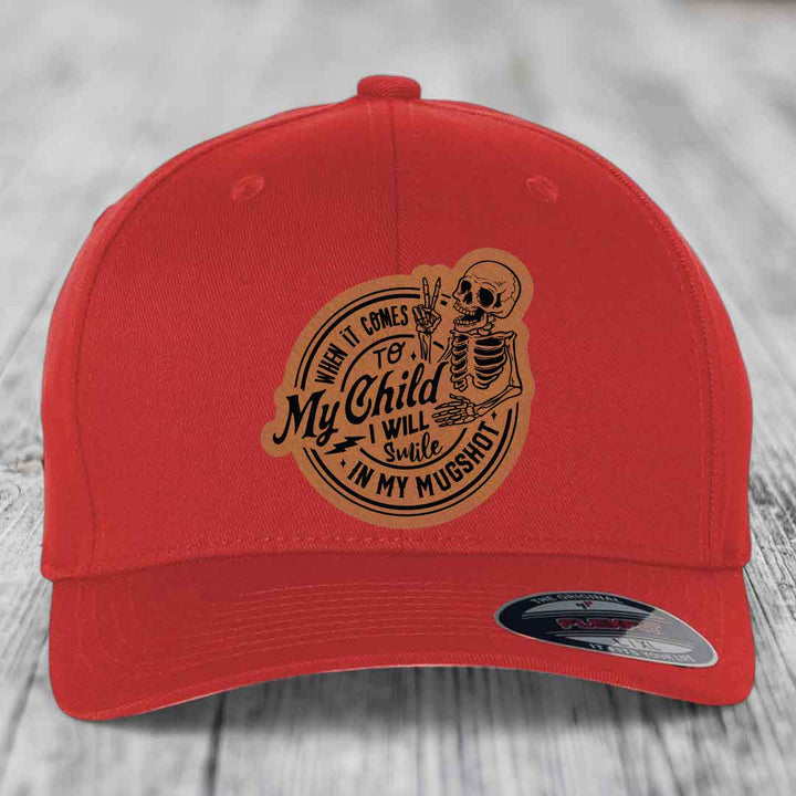 Red baseball cap with a tan leatherette patch featuring a skeleton and the text &