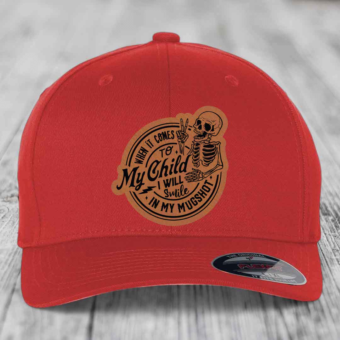 Red baseball cap with brown leatherette patch featuring skeleton and text &