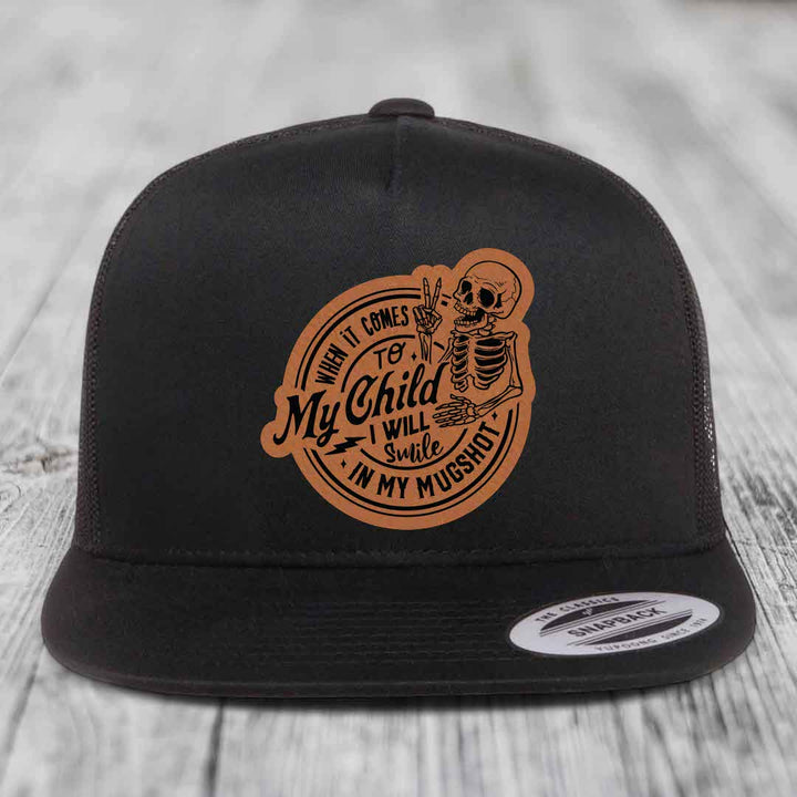 Black trucker hat with brown leather patch featuring skeleton and text &