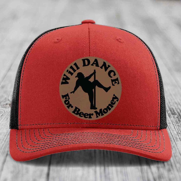 Red trucker hat with black mesh back and a circular tan patch showing a pole dancer silhouette and text &