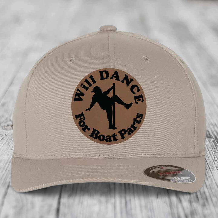 Beige baseball cap with circular brown patch showing pole dancer silhouette and text &