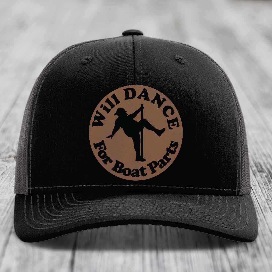 Black trucker hat with brown circular patch showing silhouette of person pole dancing and text &