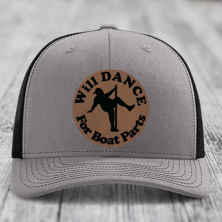 Grey trucker hat with black mesh back and a brown circular patch that reads &