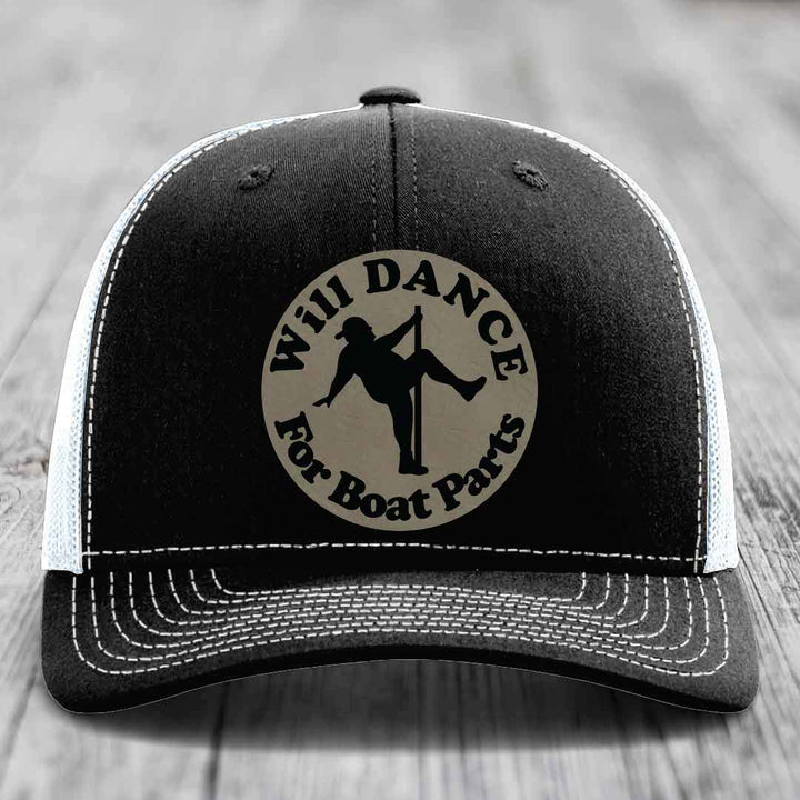 Black trucker hat with white stitching and a circular patch that says &