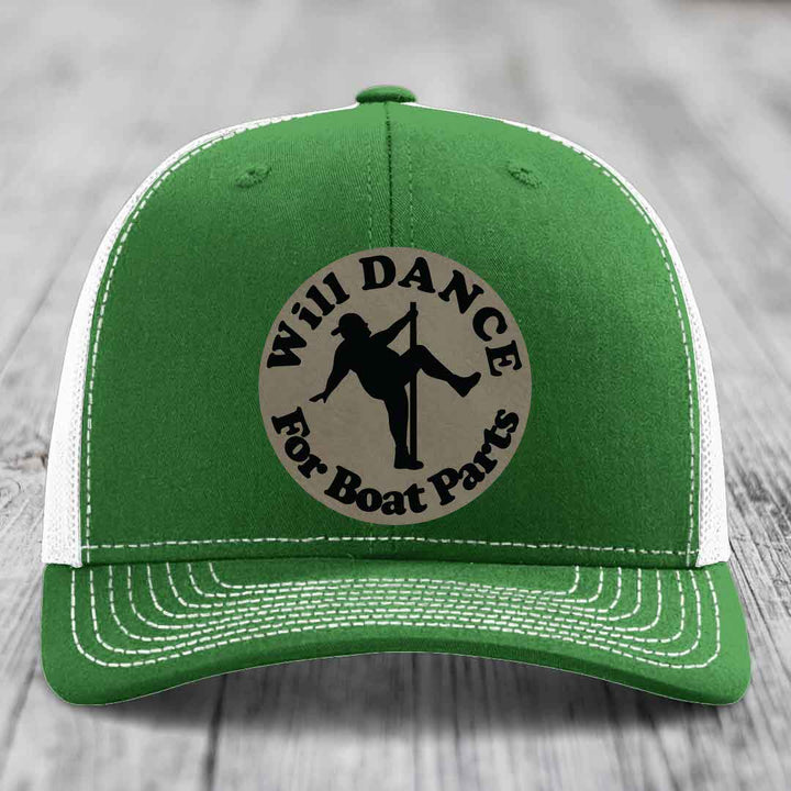 Green trucker hat with white mesh back and stitching, featuring a circular beige patch with black text reading &