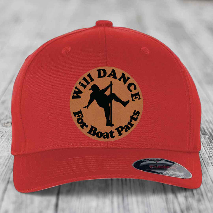 Red baseball cap with circular brown patch featuring black text and pole dancer silhouette.
