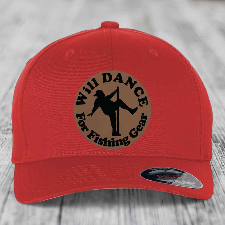 Red baseball cap with circular brown patch featuring black text and silhouette of person dancing for fishing gear.