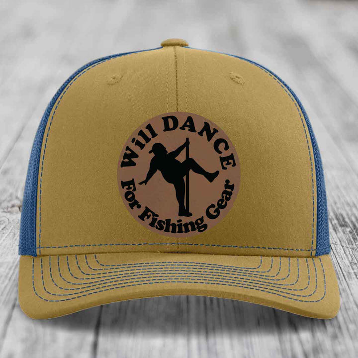 Tan trucker hat with blue mesh back and brim, featuring a circular brown leather patch that reads &