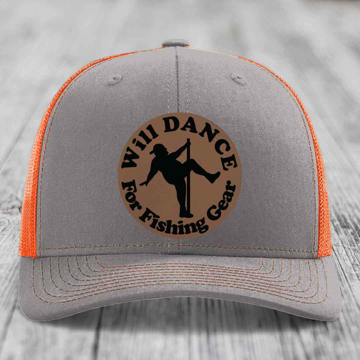 Grey trucker hat with orange mesh back and a brown leather patch that says &