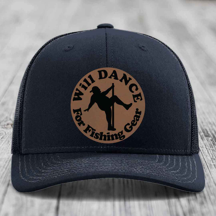 Black trucker hat with brown circular patch showing silhouette of person pole dancing and text &