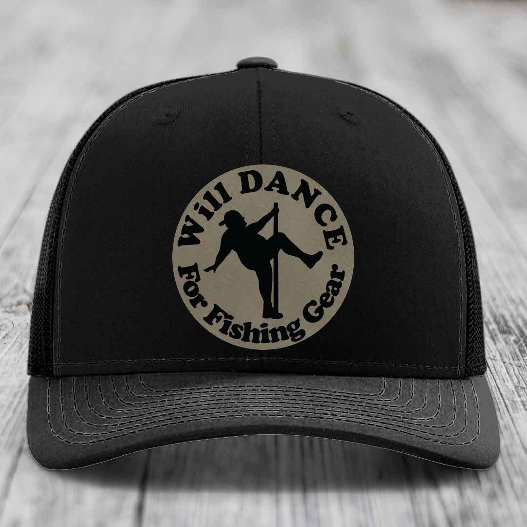 Black trucker hat with circular beige patch showing silhouette of person dancing on pole with text &