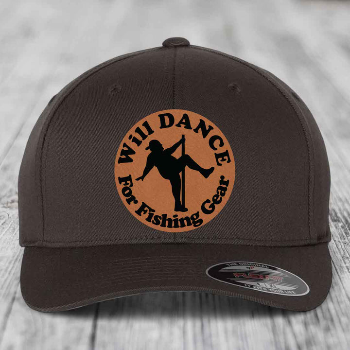 Dark brown Flexfit hat with circular tan leather patch showing silhouette of person dancing for fishing gear.