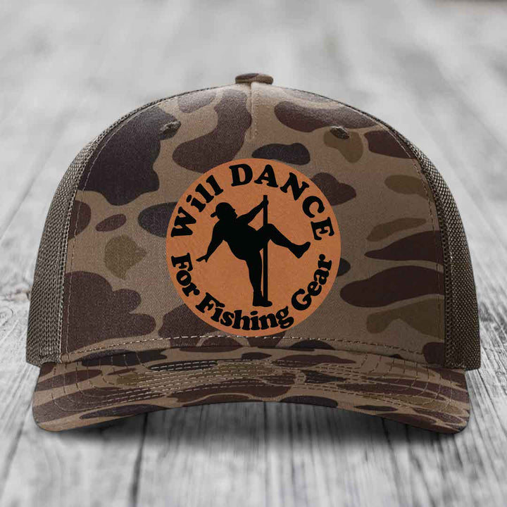 Camouflage trucker hat with brown leather patch featuring a dancer silhouette and text &