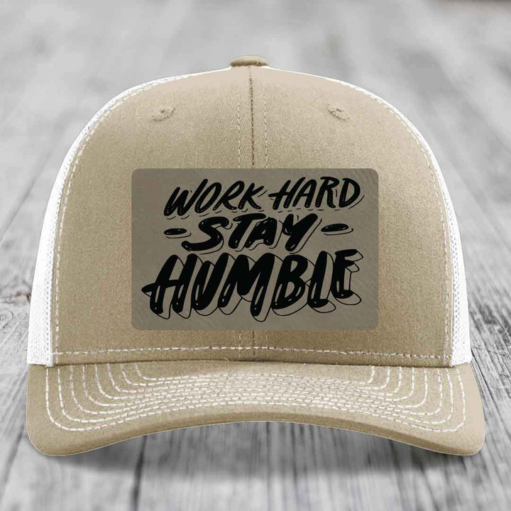 Tan trucker hat with white mesh back and black &