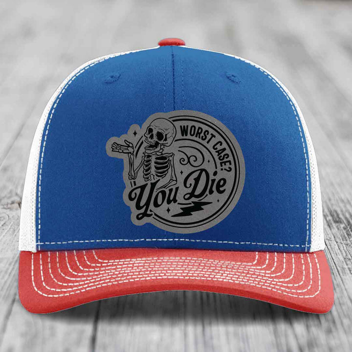 Blue and red trucker hat with a gray circular patch featuring a skeleton and the text &