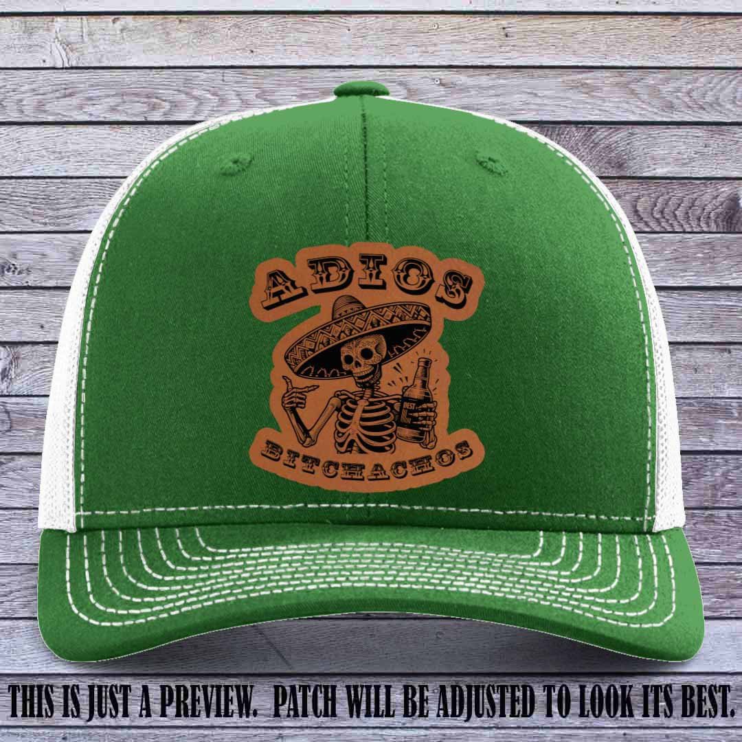 Rawhide leather patch on Kelly to White Richardson 112 trucker hat featuring “Adios Bitchachos” skeleton design.