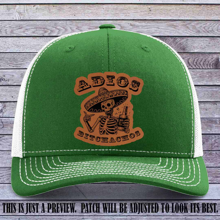 Rawhide leather patch on Kelly to White Richardson 112 trucker hat featuring “Adios Bitchachos” skeleton design.